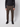 A person wears PROJEK RAW Mens Stretch Bungee Cargo Pant in brown with black sneakers, standing against a plain light background. The cropped image highlights the stretch cargo pants and focuses on the lower half of the body.