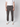 A person wears a white short-sleeve shirt, white sneakers, and PROJEK RAW Men’s Stretch Bungee Cargo Jogger with a drawstring waist, standing against a light background. The image shows the joggers’ relaxed fit from shoulders to feet.