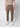 A person wears a beige t-shirt, PROJEK RAW Men’s Canvas Bungee Pull-on Cargo Jogger in olive green with a drawstring waist, and white sneakers, standing against a plain light background. The person’s head is not visible.