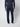 A person in a navy blue sweater, PROJEK RAW Mens 5-Pocket Flex Knit Jeans, and white sneakers stands with their back to the camera against a plain light background.