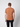 A man with short brown hair stands with his back to the camera, wearing a PROJEK RAW Mens Liquid Cotton Short Sleeve T-shirt in brown and black pants against a plain light background.