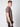 A young man with short light brown hair wears a PROJEK RAW Mens Liquid Cotton Short Sleeve T-shirt and dark jeans, standing sideways and looking toward the camera against a plain light background.