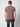 A man faces away from the camera wearing a PROJEK RAW Mens Liquid Cotton Short Sleeve T-shirt and dark jeans with visible back pockets, set against a light grey background.