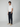 A young man stands against a plain background, wearing a white short-sleeve t-shirt, PROJEK RAW MENS DRAWSTRING CHINO PANT in navy blue with a relaxed fit, and beige slip-on shoes. He looks forward with a neutral expression and relaxed posture.