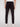 A person is shown from the back in STEPHANE-BLACK cargo pants by Projek Raw, made from bungee fabric, featuring visible back and side cargo pockets, paired with white sneakers against a plain light background.