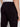 Close-up of a person wearing Projek Raw STEPHANE-BLACK cargo pants and a white shirt, highlighting the back and side leg pockets, with their arm resting by their side.