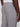 A person shown from behind at waist level wears Projek Raws LUC-GREY light gray linen drawstring pants and a white shirt, with one hand by their side and a buttoned back pocket—a relaxed summer style.