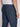 A person is shown from the back wearing Projek Raws LUC-NAVY blue linen drawstring pants with a white shirt, one hand by their side and a buttoned back pocket visible—ideal for effortless summer style.