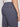 A person is shown from the back wearing Projek Raws GUSTAVE-DARK GREY knee-length shorts, highlighting the detailed stitching and visible back pockets.