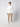 A young man with curly hair stands facing forward, wearing a white PROJEK RAW Mens Zip Mock Neck Sweater, beige pants, and white sneakers against a plain light background.