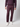 A person wears a textured, long-sleeve dark purple sweater, PROJEK RAW Mens Bungee Relaxed Chino Pant in matching purple, and white sneakers, standing against a plain light background. Only the body from shoulders down is visible.