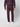 A person stands facing away, wearing a textured purple sweater, PROJEK RAW Mens Bungee Relaxed Chino Pant in matching purple, and white sneakers against a plain light background.