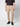 A person in a black short-sleeve shirt, PROJEK RAW Men’s Stretch Bungee Cargo Jogger, and black sneakers stands against a plain light background. The photo is cropped at the shoulders.