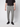 A person stands against a plain light background wearing a black short-sleeve shirt, black sneakers, and PROJEK RAW Men’s Stretch Bungee Cargo Jogger in light gray with a drawstring waist and pockets.