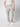 A person models PROJEK RAW Mens Bungee Loose Cargo Pant, styled with a short-sleeve white shirt and white sneakers, standing against a plain light gray background. The photo shows only the lower half of their body.