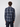 A man with curly brown hair, facing away against a white background, is wearing the PROJEK RAW Mens Plaid Corduroy Long Sleeve Shirt in dark blue and gray paired with dark pants.