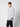 A young man with short light brown hair wears the PROJEK RAW Mens Long Sleeve Casual Dress Shirt in light gray, featuring chest pockets and black pants, standing against a plain light background with a neutral expression.