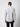 A man with short light brown hair stands with his back to the camera, wearing a PROJEK RAW Mens Long Sleeve Casual Dress Shirt in light gray and black pants, set against a plain light background.