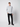 A young man stands against a plain background, wearing the PROJEK RAW Mens Long Sleeve Casual Dress Shirt with chest pockets, paired with black pants and sneakers. He faces forward with a neutral expression and relaxed posture.