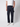 A person in a white short-sleeve shirt and white sneakers wears PROJEK RAW Mens Colored Denim Carpenter Pants with utility pockets, standing against a light gray background with one hand in their pocket.