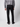 A man wearing a gray plaid shirt, PROJEK RAW Mens 5-Pocket Straight Fit Jeans in black, and black shoes stands facing away from the camera against a plain light background.