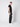 A young man stands sideways against a plain background, wearing a black t-shirt, PROJEK RAW Mens 5-Pocket Straight Fit Jeans, and white sneakers. He faces the camera with a neutral expression.