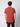 A person with short curly hair stands facing away, wearing a rust-colored PROJEK RAW Mens Short Sleeve Crewneck T-shirt and dark pants against a plain light background.
