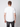 A man with short brown hair stands with his back to the camera, wearing a PROJEK RAW Mens Short Sleeve Crewneck T-shirt and dark jeans against a light gray background.