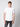 A young man with short light brown hair wears the PROJEK RAW Mens Short Sleeve Crewneck T-shirt—a plain white classic fit—paired with dark jeans, standing against a light gray background and looking directly at the camera.