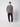 A young man stands against a plain light background, wearing the PROJEK RAW Mens Long Sleeve Crewneck T-shirt with black cargo jogger pants and white sneakers, one hand in his pocket.