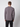 A person with short brown hair faces away from the camera, wearing a PROJEK RAW Mens Long Sleeve Crewneck T-shirt in gray and black pants, set against a simple light-colored background.
