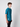 A young man with curly brown hair stands sideways, wearing a PROJEK RAW Mens Short Sleeve Crew T-shirt and black pants against a plain light gray background.