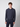 A young man with short curly hair wears the PROJEK RAW Mens Long Sleeve Hoodie with Kangaroo Pocket, paired with matching pants, standing against a plain light gray background and facing the camera with a neutral expression.