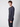 A young man with curly hair wears the PROJEK RAW Mens Long Sleeve Hoodie with Kangaroo Pocket and matching pants, standing against a plain light gray background and looking at the camera with a neutral expression.
