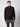 A person stands facing forward, wearing the PROJEK RAW Mens Long Sleeve Full Zip Mock Neck Sweater paired with dark gray pants against a plain light background.