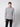 A young man stands against a plain light gray background, wearing the PROJEK RAW Mens Cable Knit Mock Neck Sweater and black pants. He faces forward with a neutral expression, arms at his sides.