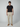 A man stands facing forward against a plain background, wearing a black t-shirt, tan sneakers, and PROJEK RAW Mens Bungee Loose Cargo Pant.