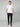 A man stands against a plain background, wearing a white short-sleeve t-shirt, brown shoes, and PROJEK RAW MENS CHINO SIGNATURE WOVEN PANT with a tailored fit. He has one hand in his pocket and maintains a neutral expression.