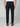 A man faces away wearing PROJEK RAW MENS CHINO SIGNATURE WOVEN PANT in dark navy, styled with a white shirt and brown suede loafers. The tailored pants offer belt loops, buttoned back pockets, and a refined silhouette.