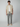 A man faces forward in a beige short-sleeve shirt over a white tee, PROJEK RAW Mens Drawstring Linen Pant in gray, and beige loafers against a plain light background.
