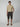 A young man stands against a light background wearing a beige t-shirt, brown sandals, and PROJEK RAW Mens Solid Bungee Pull-on Cargo Shorts with an elastic waistband. One hand is in his pocket as he looks ahead with a neutral expression.