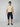 A man stands against a plain background wearing sunglasses, a short-sleeve beige polo, PROJEK RAW Mens Solid Bungee Capri Cargo Shorts 13 Inseam, and black slip-on shoes.