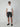 A man in sunglasses, a plain white tee, PROJEK RAW MENS BUNGEE PLAID CHINO SHORTS, and black slip-ons stands facing forward against a plain light gray background.