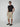 A man wearing sunglasses, a black t-shirt, and PROJEK RAW MENS PULL-ON CARGO SHORT stands in a neutral studio setting with his left hand in his pocket.