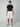 A young man faces forward in a neutral pose, sporting PROJEK RAW MENS CARGO CAPRI SHORTS with a belt, a fitted black t-shirt, and gray-white sneakers—an effortlessly stylish casual look against a plain background.