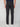 A person wearing PROJEK RAW MENS 5-POCKET SOLID BUNGEE PANT with a black belt and white sneakers stands facing away from the camera against a plain light background.