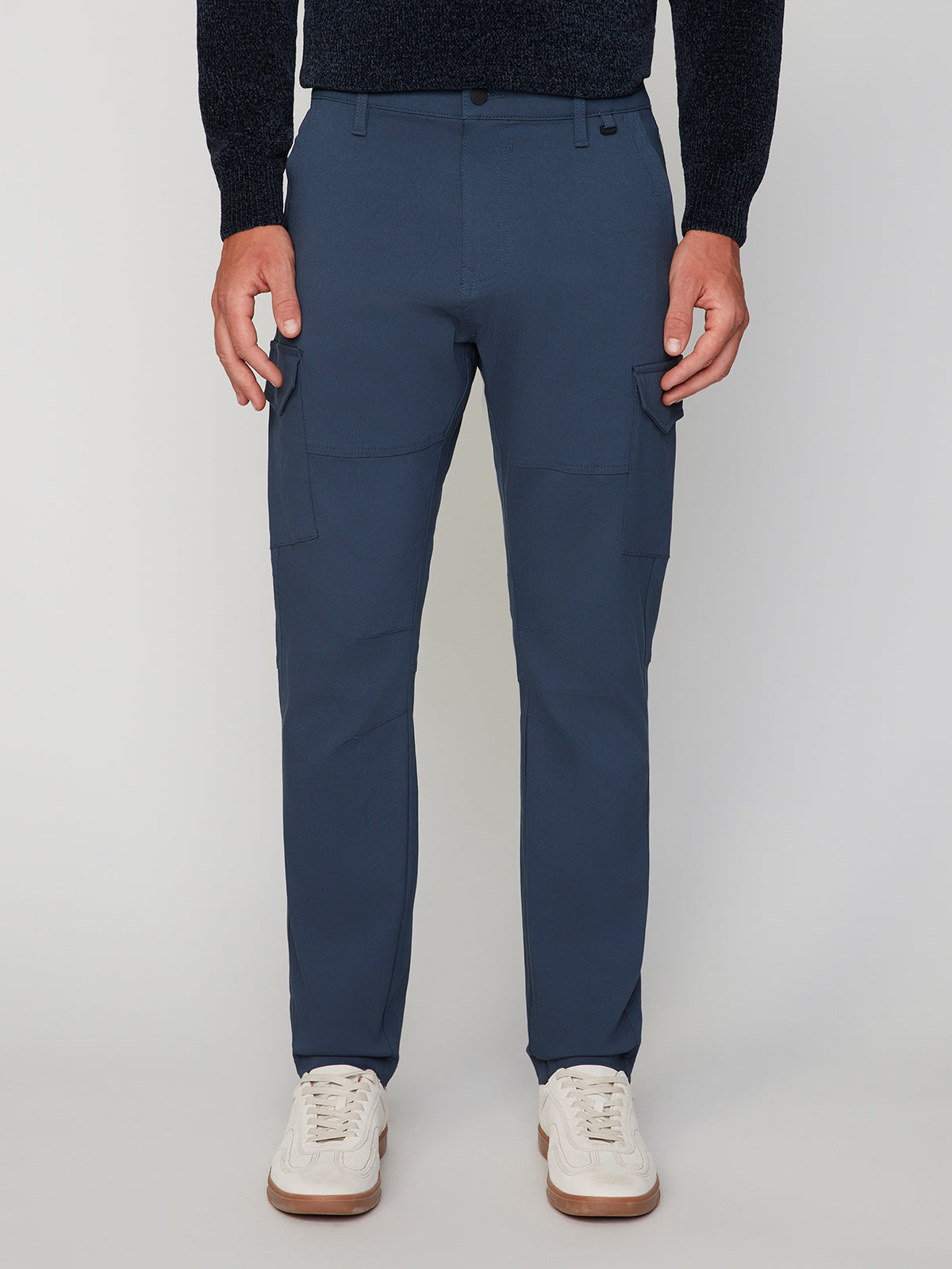 A person wearing PROJEK RAW MENS SOLID BUNGEE CARGO PANT with side pockets, a dark long-sleeve top, and white sneakers stands against a light background. The image is cropped at the shoulders for a modern streetwear vibe.