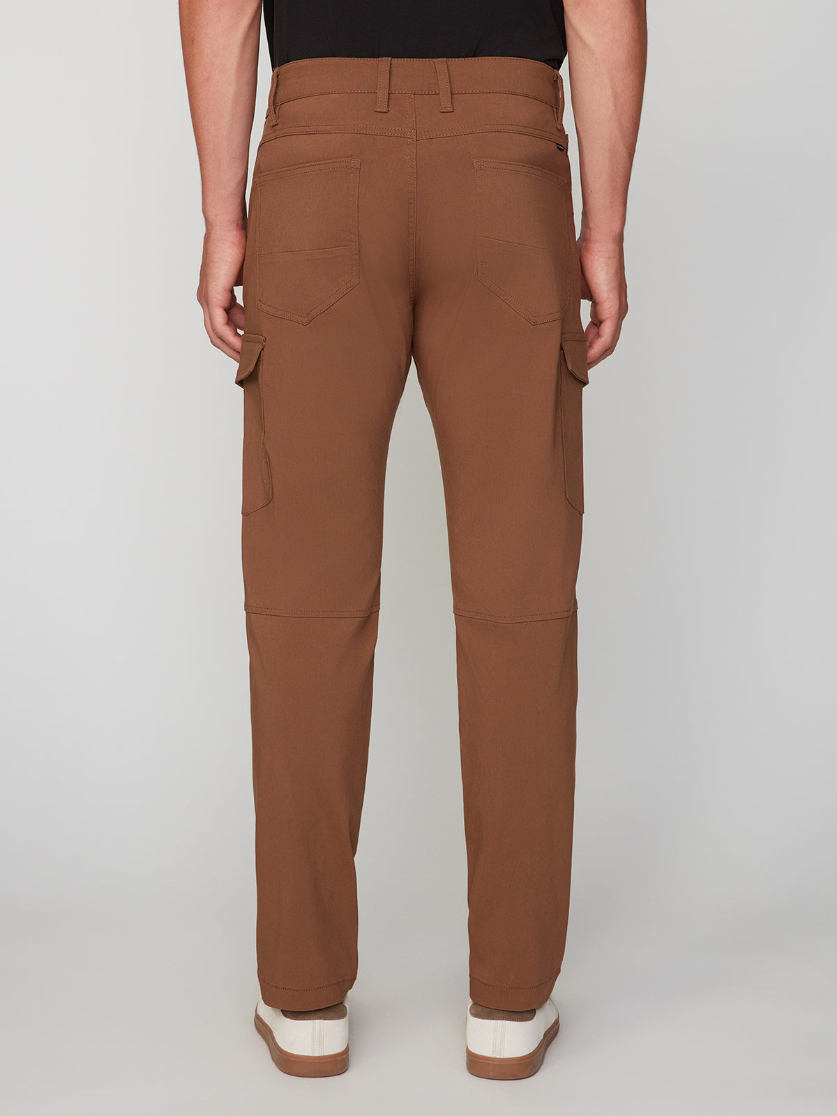 A person is shown from the back wearing PROJEK RAW MENS SOLID BUNGEE CARGO PANT with an elasticized waistband, back and side cargo pockets, styled with white sneakers against a plain light background for a streetwear-inspired look.