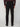 A person wearing PROJEK RAW MENS 5-POCKET SOLID BUNGEE CHINO PANT, black shoes, and a dark long-sleeve shirt stands facing away from the camera against a plain light background.