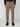 Wearing PROJEK RAW MENS SOLID BUNGEE CARGO JOGGER pants with thigh pockets and elastic cuffs, a black long-sleeve top, and black shoes, a person stands against a plain light gray background.